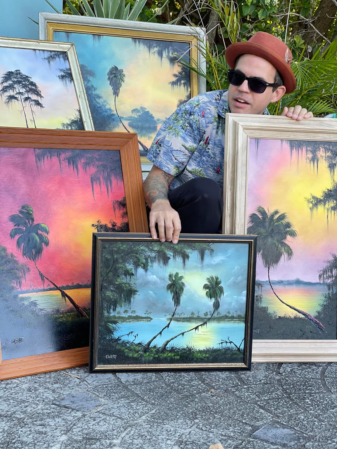Artist West Evans with his original Florida landscape paintings
